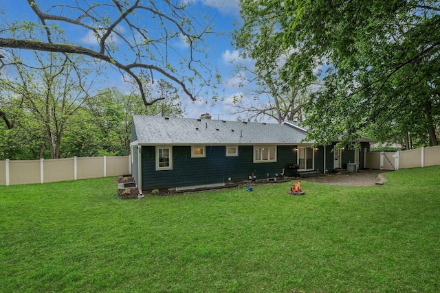 5078 Vine Hill Rd, Deephaven, MN 55331 - back of property with an outdoor fire pit, a chimney, and roof with shingles