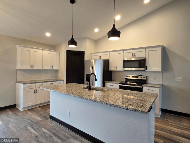 320 Gloria Dr, Green Isle, MN 55338 - kitchen featuring appliances with stainless steel finishes, vaulted ceiling, a sink, tasteful backsplash, and dark wood-style flooring