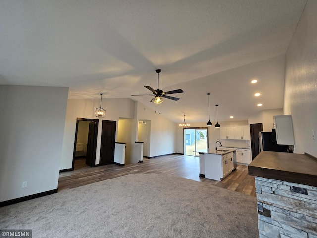 320 Gloria Dr, Green Isle, MN 55338 - kitchen featuring a sink, vaulted ceiling, a chandelier, open floor plan, and white cabinetry