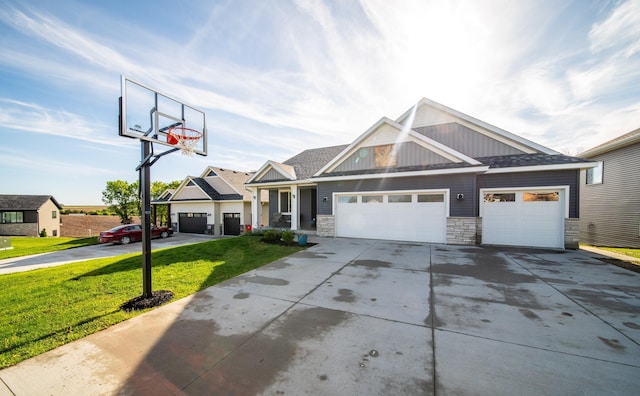 1004 Blanch Ct, Mantorville, MN 55955 - craftsman-style home with a front yard, driveway, stone siding, an attached garage, and board and batten siding