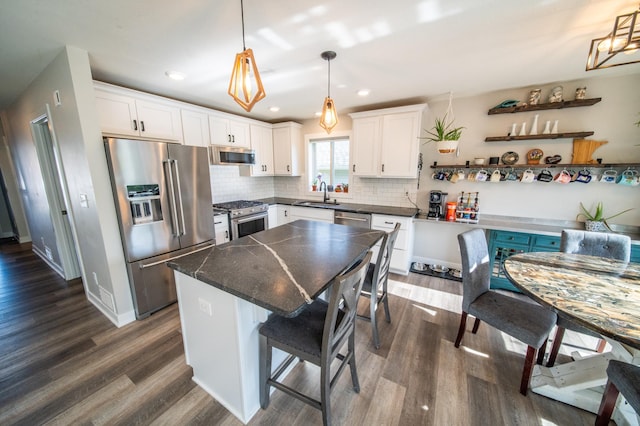 1004 Blanch Ct, Mantorville, MN 55955 - kitchen featuring high quality appliances, dark countertops, dark wood finished floors, white cabinetry, and recessed lighting