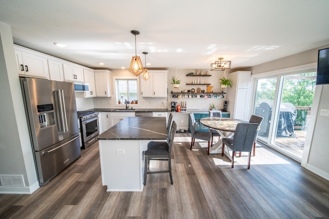 1004 Blanch Ct, Mantorville, MN 55955 - kitchen featuring stainless steel appliances, a sink, dark countertops, and dark wood-type flooring