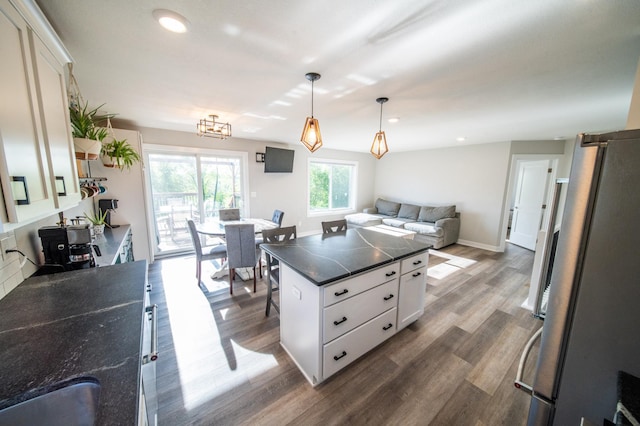 1004 Blanch Ct, Mantorville, MN 55955 - kitchen with dark countertops, white cabinets, dark wood-type flooring, open floor plan, and recessed lighting