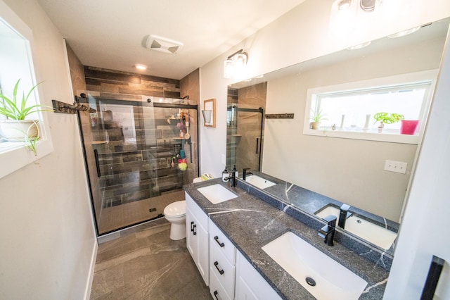 1004 Blanch Ct, Mantorville, MN 55955 - full bathroom featuring double vanity, a stall shower, and toilet
