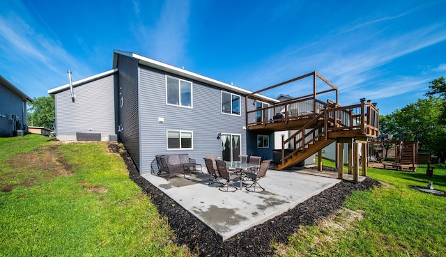 1004 Blanch Ct, Mantorville, MN 55955 - back of house featuring stairway, a lawn, a deck, and a patio
