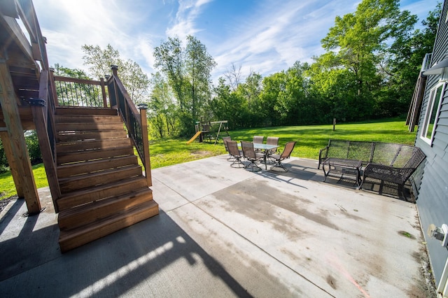 1004 Blanch Ct, Mantorville, MN 55955 - view of patio featuring a playground, outdoor dining space, stairway, and view of wooded area