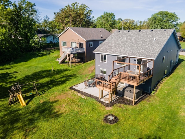 1004 Blanch Ct, Mantorville, MN 55955 - rear view of property featuring roof with shingles, a patio area, a deck, and a yard