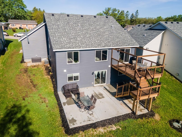 1004 Blanch Ct, Mantorville, MN 55955 - back of property with a shingled roof, a wooden deck, a patio area, a lawn, and cooling unit
