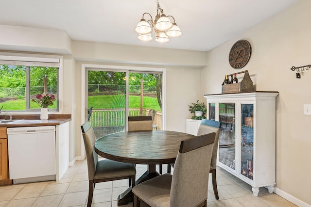1686 Walnut Ln, Eagan, MN 55122 - dining area featuring light tile patterned floors, a chandelier, healthy amount of natural light, and baseboards