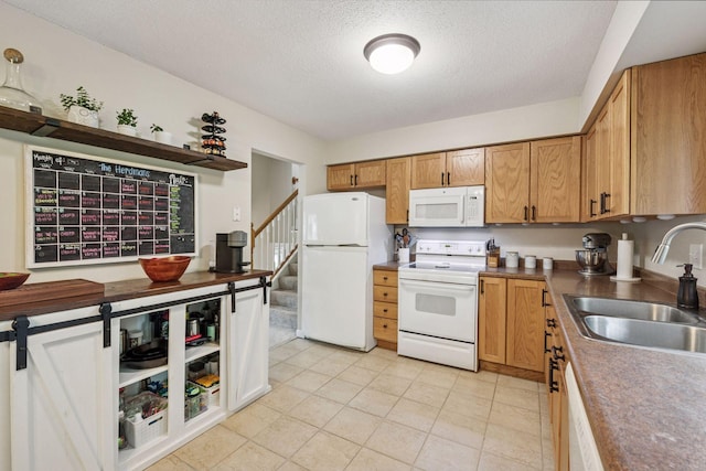 1686 Walnut Ln, Eagan, MN 55122 - kitchen featuring white appliances, a sink, a textured ceiling, light tile patterned floors, and brown cabinetry