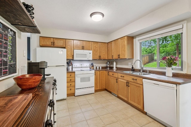 1686 Walnut Ln, Eagan, MN 55122 - kitchen with white appliances, a sink, dark countertops, a textured ceiling, and light tile patterned floors