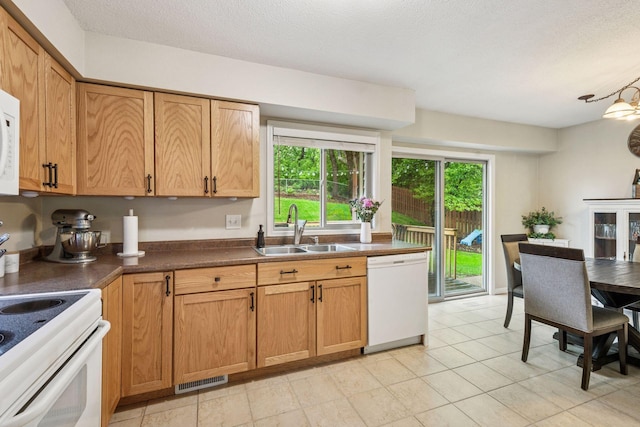 1686 Walnut Ln, Eagan, MN 55122 - kitchen featuring white appliances, a sink, dark countertops, and a textured ceiling