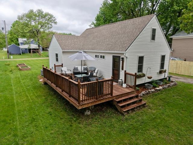 2728 Pine Ave, Slayton, MN 56172 - back of house with an outdoor living space, a deck, a shingled roof, and a yard