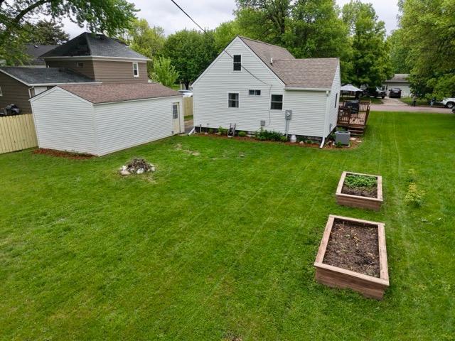 2728 Pine Ave, Slayton, MN 56172 - view of yard featuring a garden, a deck, and an outbuilding