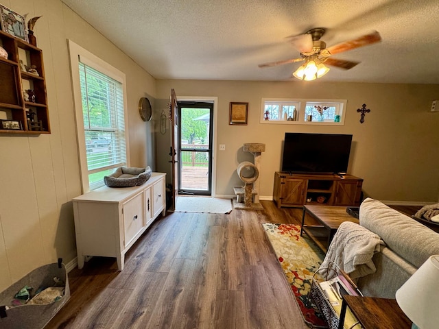 2728 Pine Ave, Slayton, MN 56172 - living room featuring a textured ceiling, dark wood finished floors, ceiling fan, and baseboards