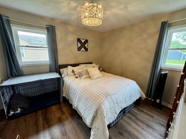 2728 Pine Ave, Slayton, MN 56172 - bedroom featuring a chandelier, wood finished floors, and baseboards