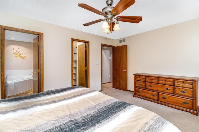39 154th Ave NE, Ham Lake, MN 55304 - bedroom with light colored carpet, ensuite bath, and a ceiling fan