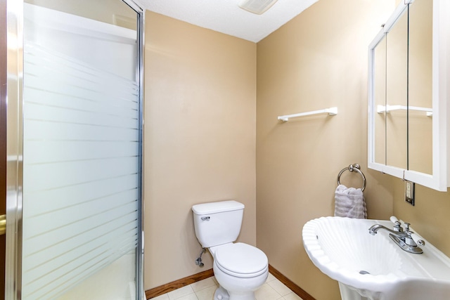 39 154th Ave NE, Ham Lake, MN 55304 - full bath featuring a sink, baseboards, a shower stall, toilet, and tile patterned flooring
