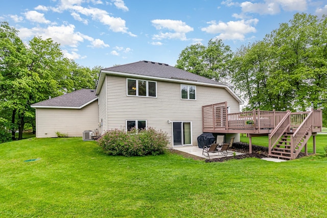 39 154th Ave NE, Ham Lake, MN 55304 - back of house with a wooden deck, a patio, a shingled roof, cooling unit, and a lawn