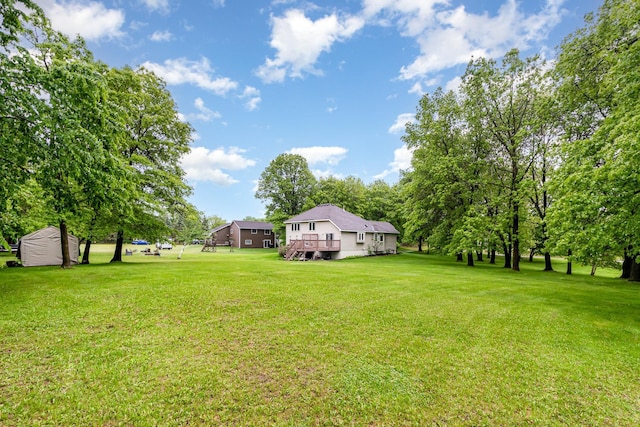 39 154th Ave NE, Ham Lake, MN 55304 - view of green lawn with a deck and an outbuilding