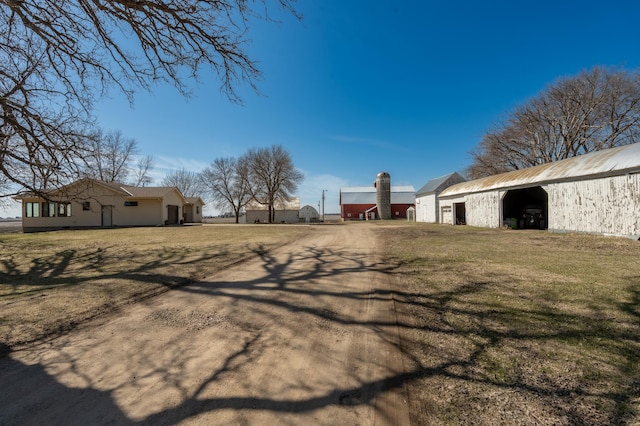 36350 276th St, Henderson, MN 56044 - view of grassy yard with a garage, an outdoor structure, driveway, and a pole building