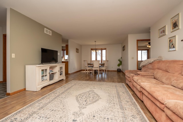 36350 276th St, Henderson, MN 56044 - living area featuring wood finished floors, baseboards, and a chandelier
