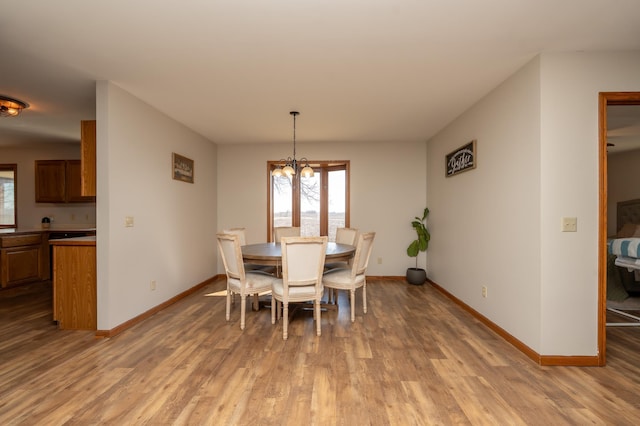 36350 276th St, Henderson, MN 56044 - dining space with wood finished floors, baseboards, and a chandelier