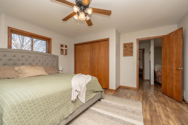36350 276th St, Henderson, MN 56044 - bedroom featuring wood finished floors, a closet, baseboards, and a ceiling fan