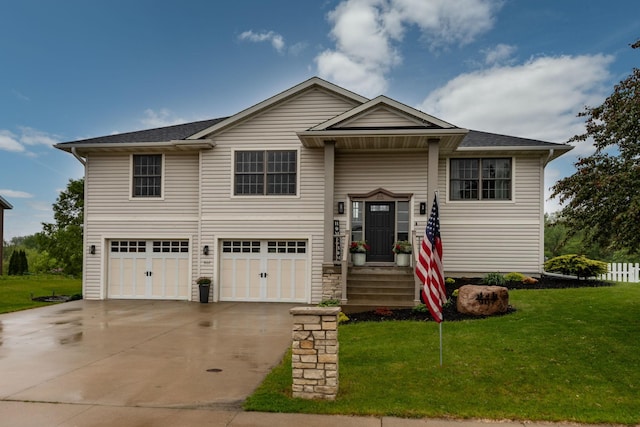 907 Rodeo Dr SE, Pine Island, MN 55963 - raised ranch featuring a garage, a front lawn, driveway, and roof with shingles