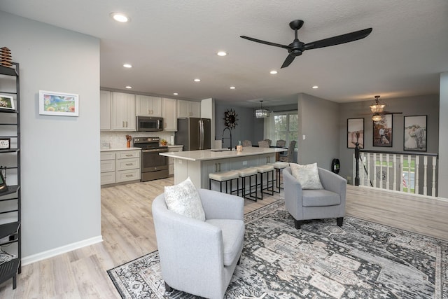 907 Rodeo Dr SE, Pine Island, MN 55963 - living area featuring light wood-type flooring, ceiling fan, recessed lighting, and baseboards