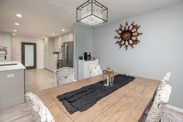907 Rodeo Dr SE, Pine Island, MN 55963 - dining area featuring light wood-style floors, recessed lighting, and a chandelier
