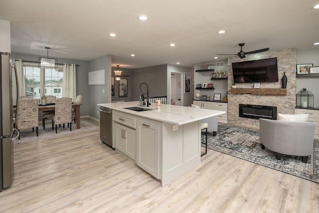907 Rodeo Dr SE, Pine Island, MN 55963 - kitchen featuring ceiling fan, a sink, appliances with stainless steel finishes, light wood-type flooring, and recessed lighting