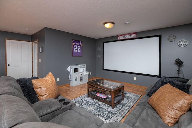 907 Rodeo Dr SE, Pine Island, MN 55963 - home theater with wood finished floors, baseboards, and a textured ceiling