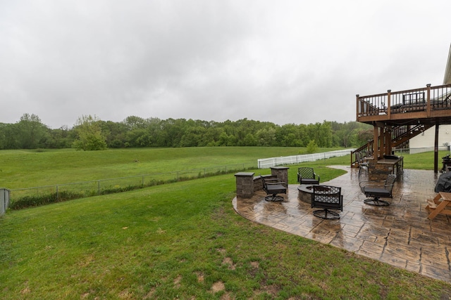 907 Rodeo Dr SE, Pine Island, MN 55963 - view of yard with stairway, a fire pit, a deck, a patio area, and a forest view
