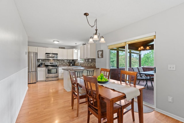 27385 Millicent Ln, Chisago Lake Twp, MN 55013 - dining space with light wood finished floors and a chandelier