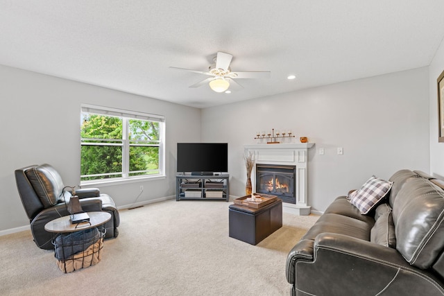 27385 Millicent Ln, Chisago Lake Twp, MN 55013 - living room featuring light colored carpet, a ceiling fan, baseboards, a glass covered fireplace, and recessed lighting