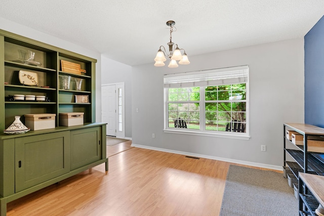 27385 Millicent Ln, Chisago Lake Twp, MN 55013 - office space featuring a chandelier, light wood-style floors, baseboards, and a textured ceiling