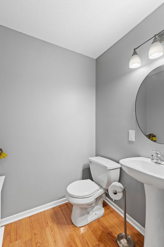 27385 Millicent Ln, Chisago Lake Twp, MN 55013 - half bathroom featuring wood finished floors, toilet, and baseboards
