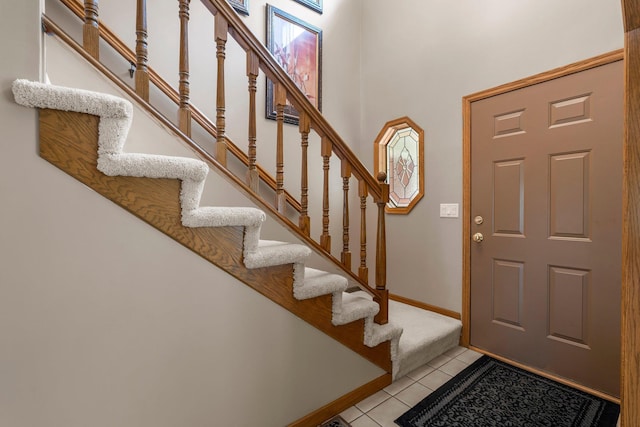 500 Mackubin Cir, Shoreview, MN 55126 - foyer entrance with light tile patterned flooring, stairs, baseboards, and a high ceiling