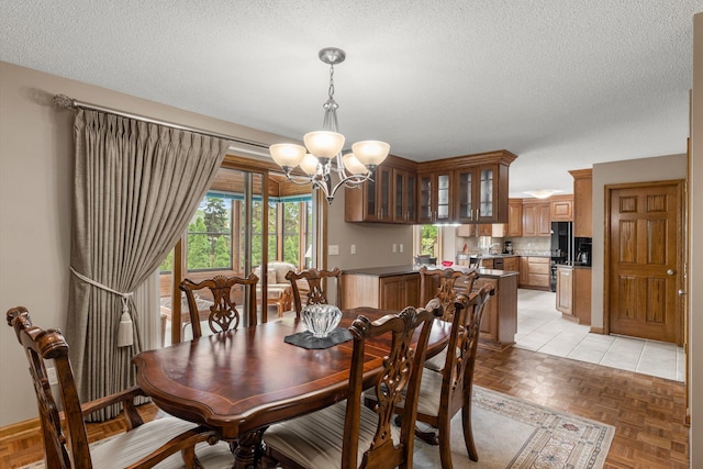 500 Mackubin Cir, Shoreview, MN 55126 - dining space featuring a chandelier and a textured ceiling