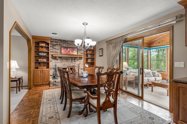 500 Mackubin Cir, Shoreview, MN 55126 - dining space with a chandelier, a textured ceiling, and built in shelves