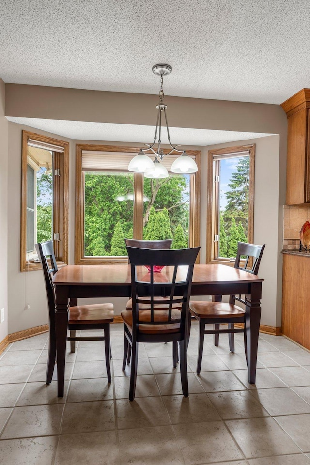 500 Mackubin Cir, Shoreview, MN 55126 - dining space with healthy amount of natural light, baseboards, light tile patterned flooring, and a textured ceiling