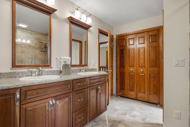 500 Mackubin Cir, Shoreview, MN 55126 - full bathroom with a tile shower, double vanity, and a textured ceiling
