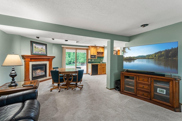 500 Mackubin Cir, Shoreview, MN 55126 - carpeted living room with a tiled fireplace, bar, a textured ceiling, and baseboards