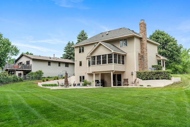 500 Mackubin Cir, Shoreview, MN 55126 - back of property with a patio, a sunroom, and a chimney