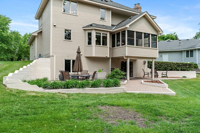 500 Mackubin Cir, Shoreview, MN 55126 - rear view of house featuring a patio area, a sunroom, a chimney, a lawn, and roof with shingles