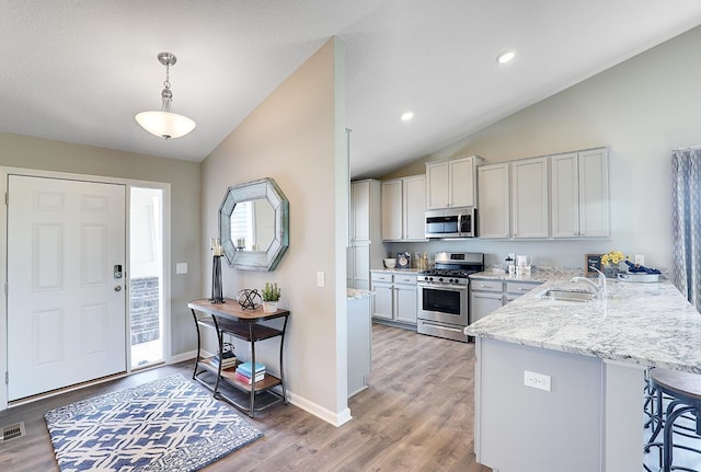 foyer featuring lofted ceiling, light wood-type flooring, baseboards, and recessed lighting