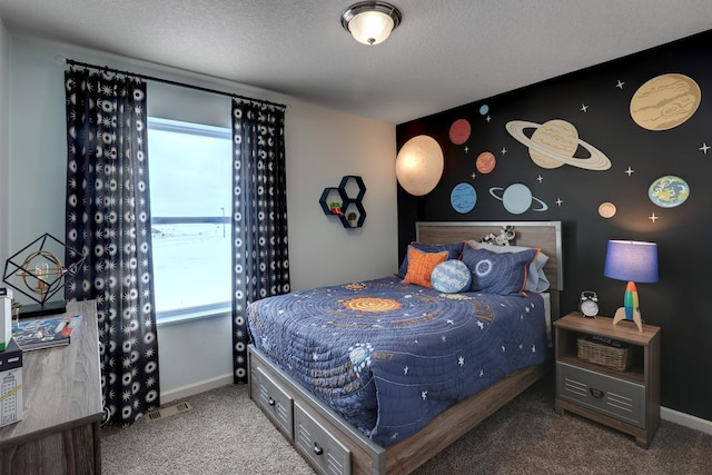 bedroom featuring carpet floors, baseboards, and a textured ceiling