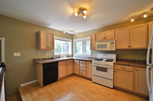 809 7th St, Brainerd, MN 56401 - kitchen with white appliances, a sink, dark countertops, light wood-type flooring, and light brown cabinetry