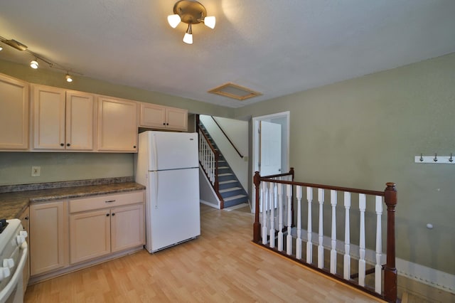 809 7th St, Brainerd, MN 56401 - kitchen with white appliances, light wood-style floors, dark countertops, and baseboards